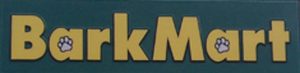 Sign featuring the text "BarkMart" in large yellow letters on a green background. The letters "a" in "Bark" and "a" in "Mart" have small paw print designs within them.